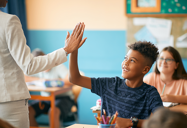 Teacher high-fiving student.